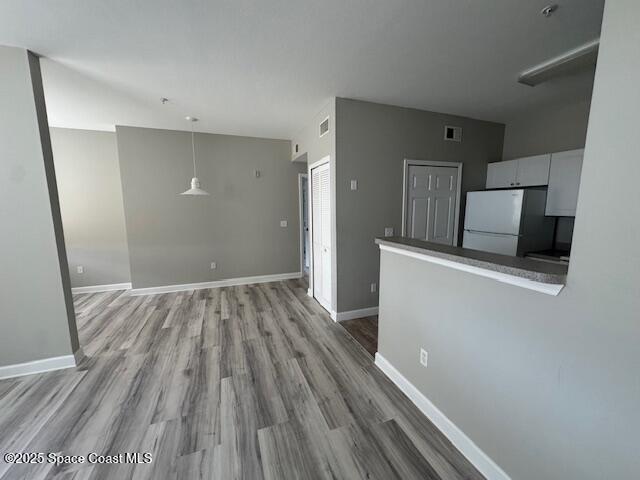 5692 Star Rush Drive, Unit 106 Melbourne, FL 32940 - Photo 9 of 16 a view of hallway with wooden floor