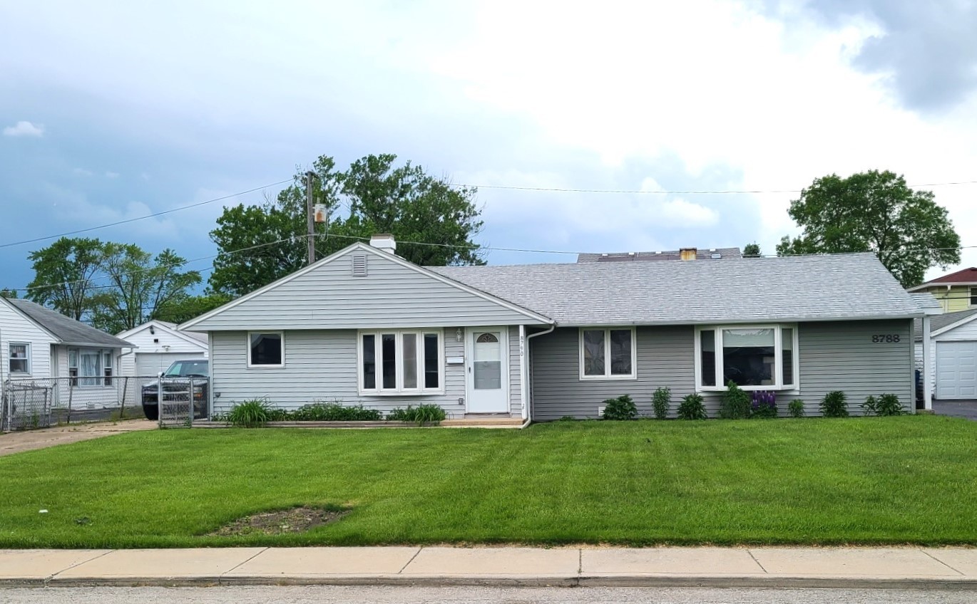 8790 South Corcoran Road, Unit 8790 Hometown, IL 60456 - Photo 1 of 14 a front view of a house with a garden