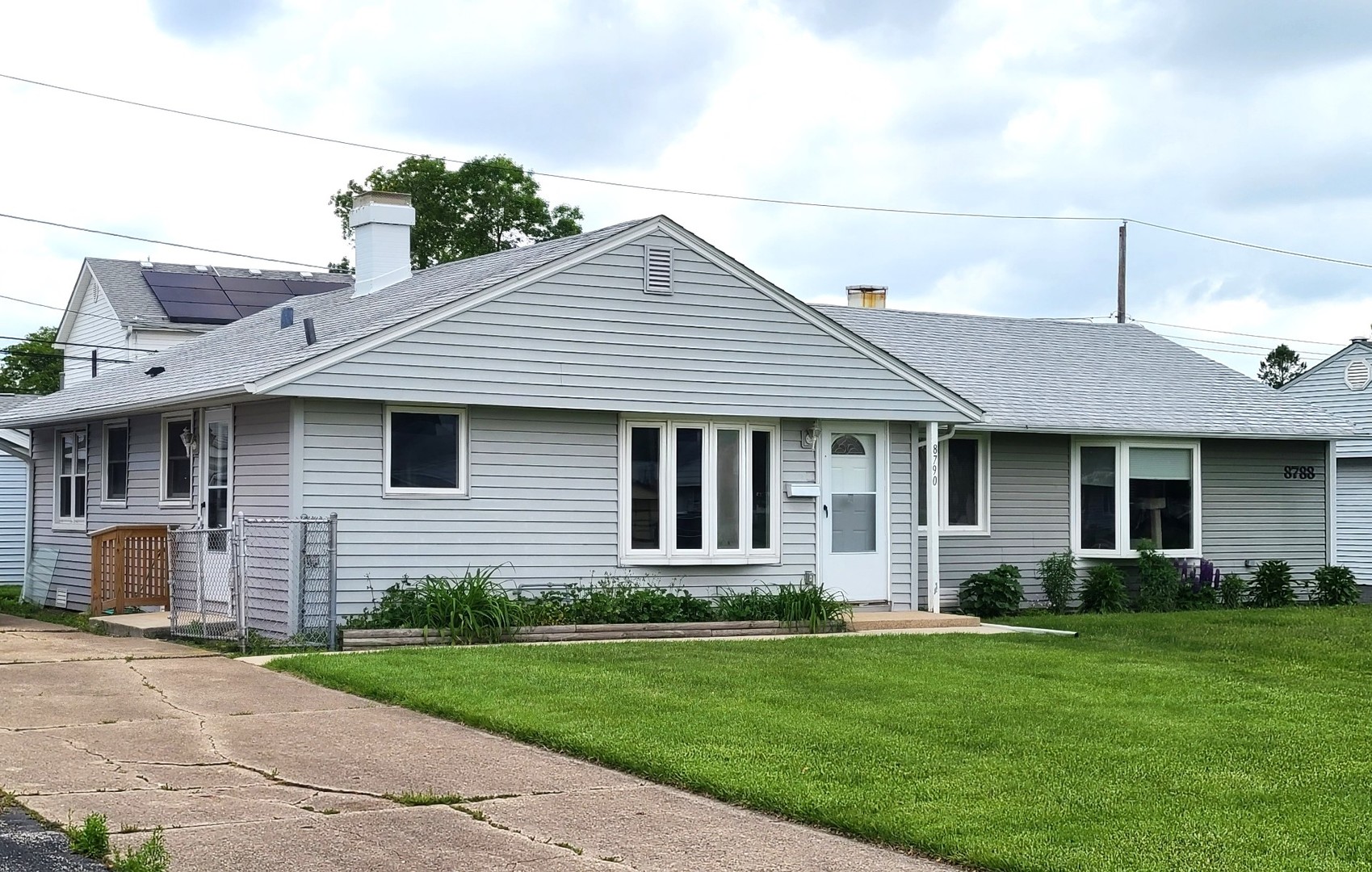 8790 South Corcoran Road, Unit 8790 Hometown, IL 60456 - Photo 3 of 14 a front view of a house with a garden and yard