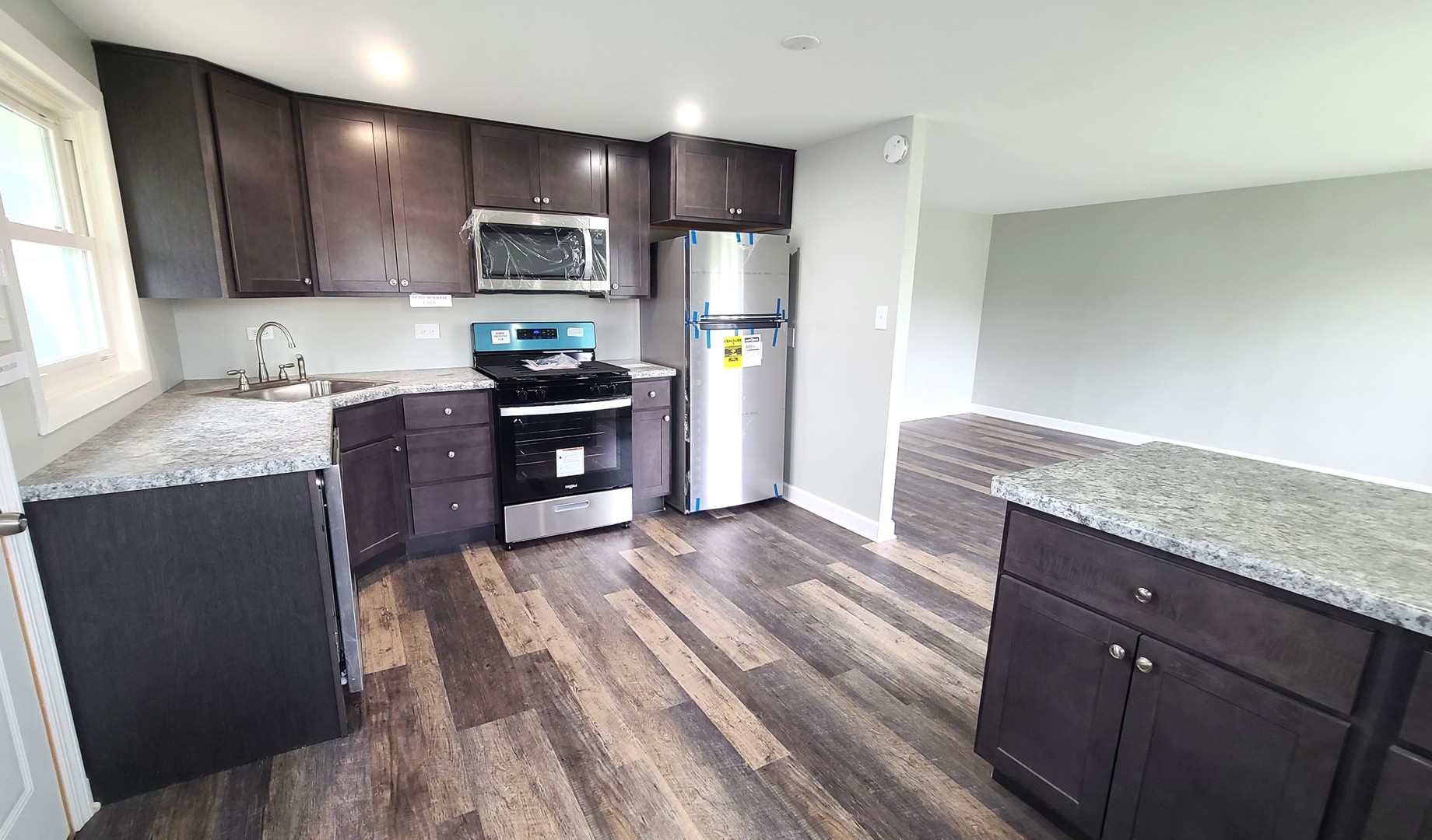 8790 South Corcoran Road, Unit 8790 Hometown, IL 60456 - Photo 6 of 14 a kitchen with granite countertop wooden cabinets and stainless steel appliances