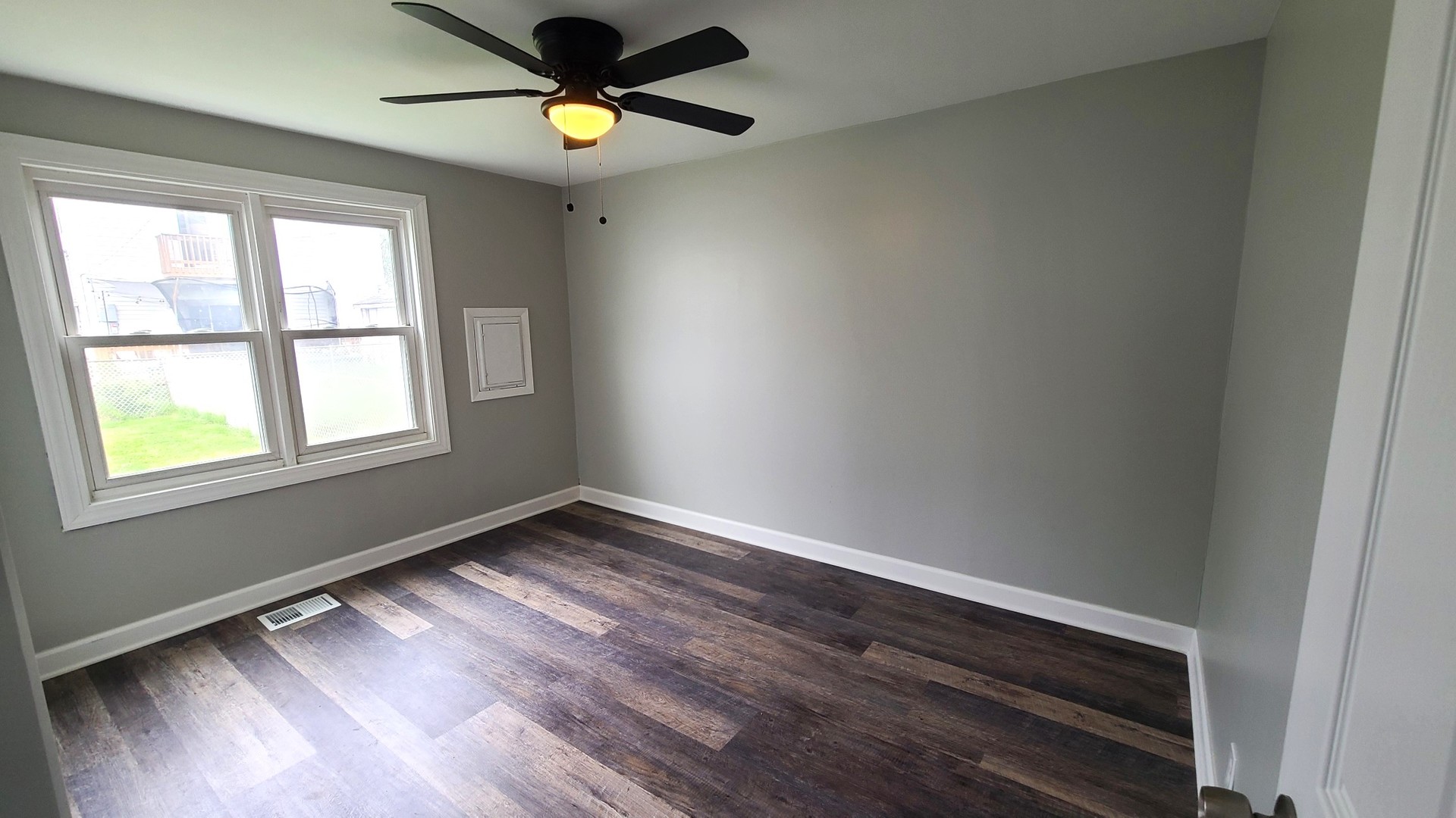 8790 South Corcoran Road, Unit 8790 Hometown, IL 60456 - Photo 8 of 14 a view of an empty room with window and wooden floor