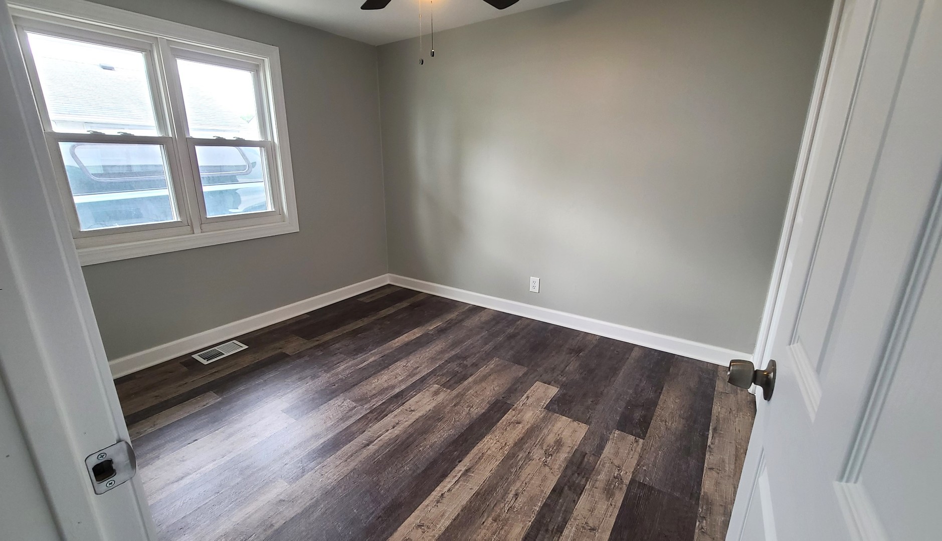 8790 South Corcoran Road, Unit 8790 Hometown, IL 60456 - Photo 9 of 14 an empty room with wooden floor and windows