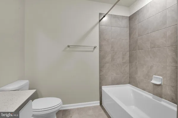 a bathroom with a bathtub and toilet