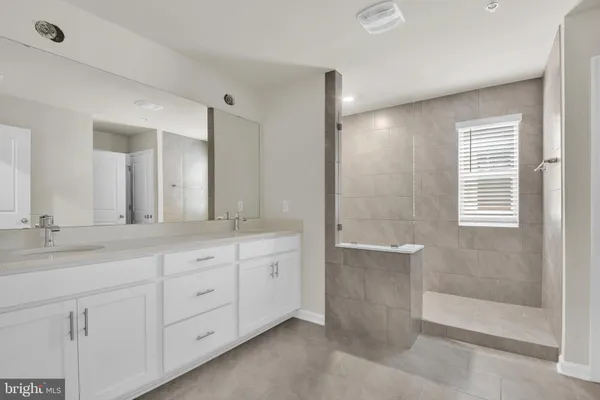 a bathroom with a granite countertop sink mirror and double