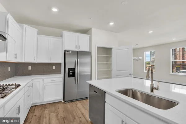 a kitchen with a sink stove and refrigerator