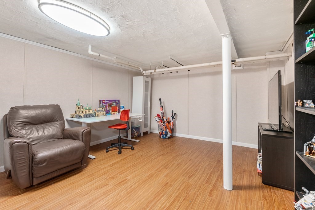 60 Valley Road Milton, MA 02186 - Photo 20 of 28 a living room with furniture and a flat screen tv