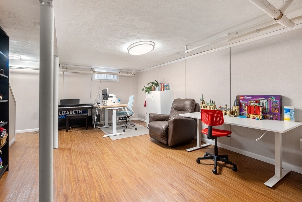 60 Valley Road Milton, MA 02186 - Photo 21 of 28 a room with furniture and a wooden floor