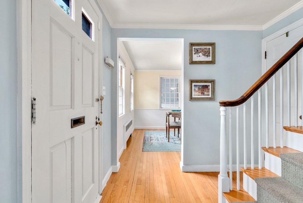 60 Valley Road Milton, MA 02186 - Photo 3 of 28 a view of a hallway with wooden floor and staircase