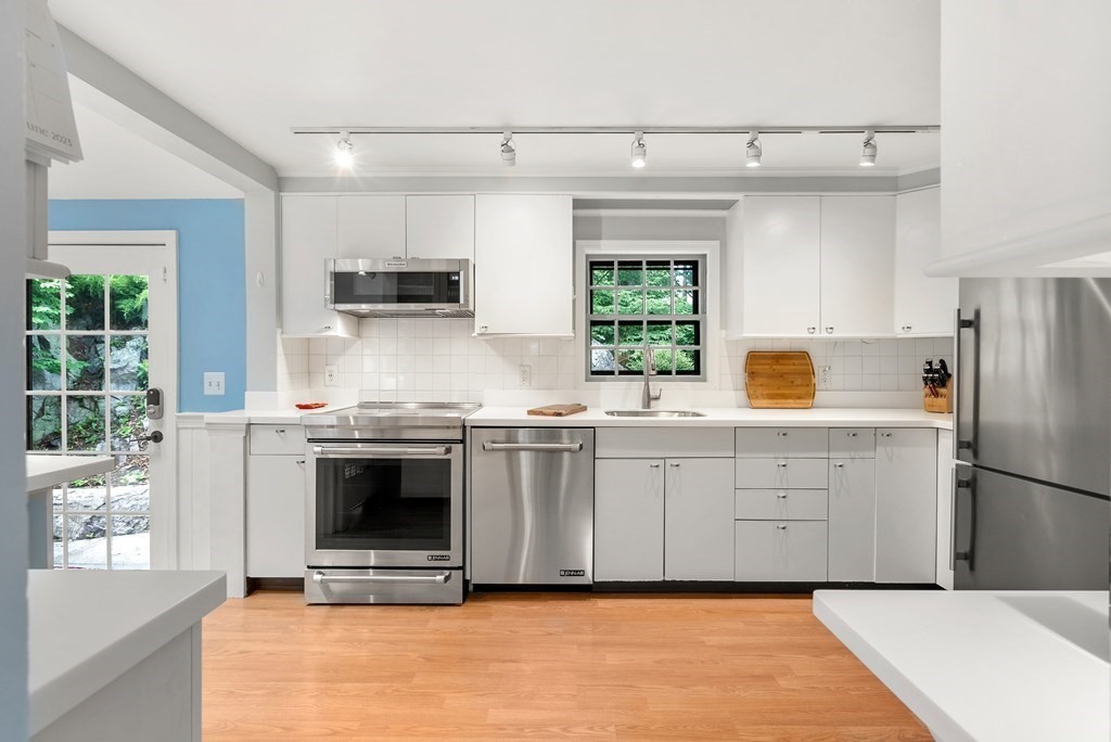 60 Valley Road Milton, MA 02186 - Photo 6 of 28 a kitchen with stainless steel appliances granite countertop a stove a sink and a refrigerator