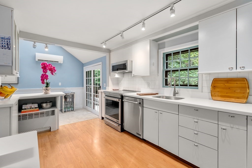 60 Valley Road Milton, MA 02186 - Photo 8 of 28 a kitchen with granite countertop stainless steel appliances a stove sink and microwave