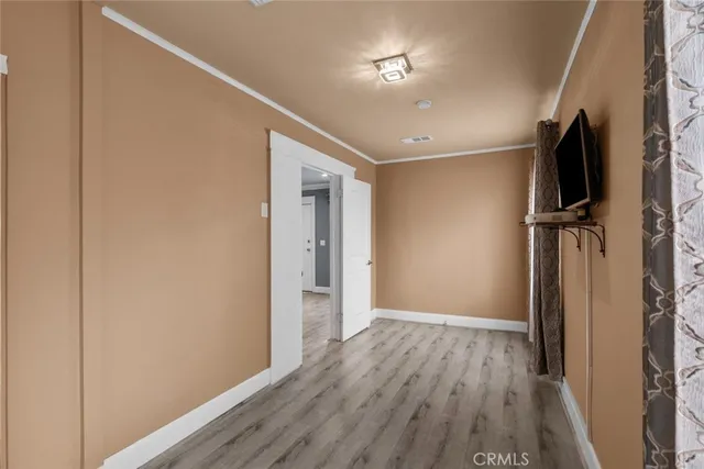 a view of hallway with wooden floor