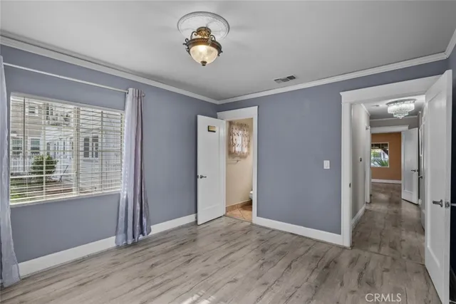 a view of a room with wooden floor and a window