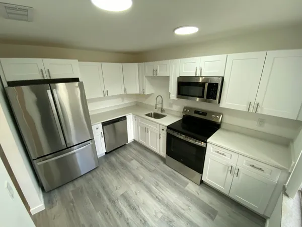 a kitchen with a refrigerator stove and microwave