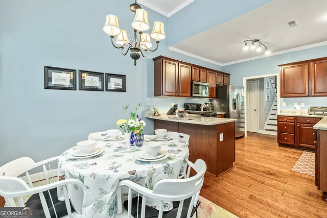a kitchen with a sink stove top oven and refrigerator