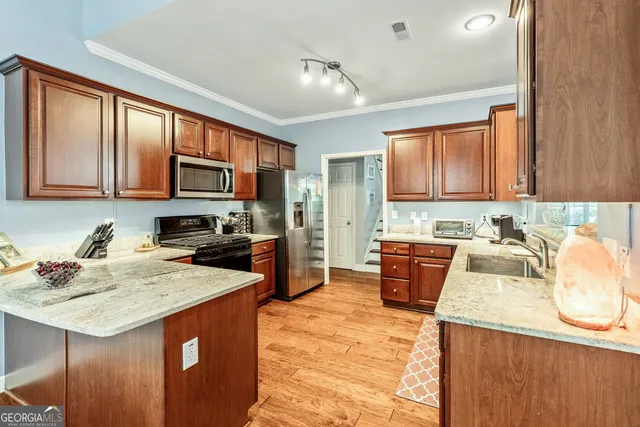 a large kitchen with kitchen island granite countertop a sink and a stove