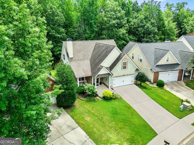 an aerial view of a house with outdoor space and a lake view