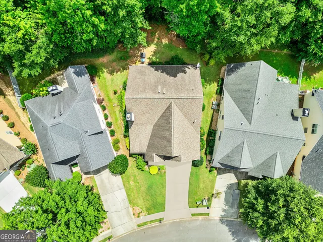 an aerial view of a house with a yard and outdoor seating