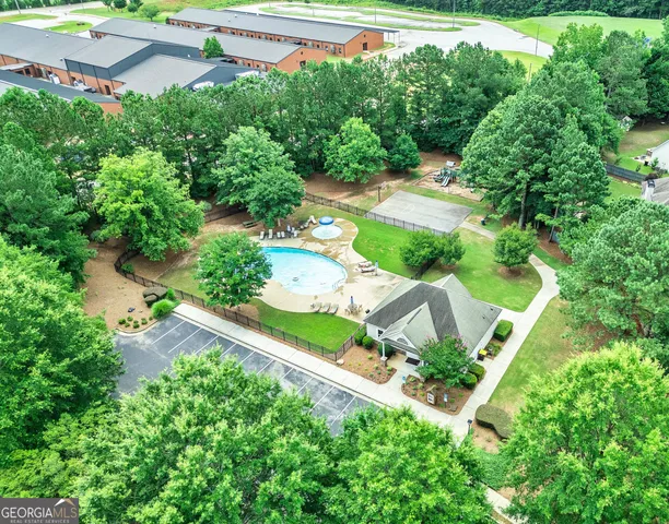 an aerial view of a house with a yard basket ball court and outdoor seating