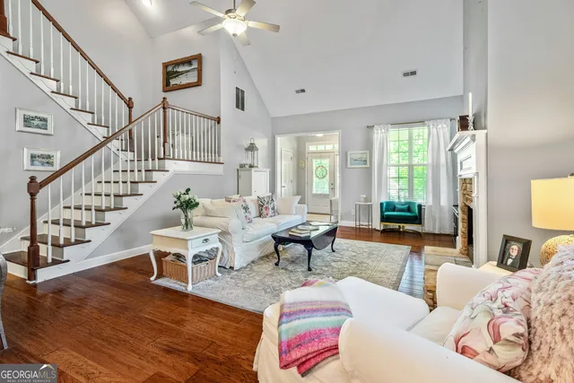 a living room with fireplace furniture and a flat screen tv
