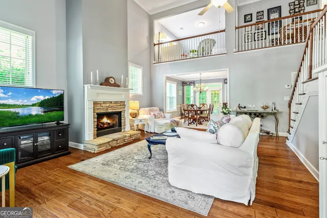 a living room with furniture a flat screen tv and a fireplace