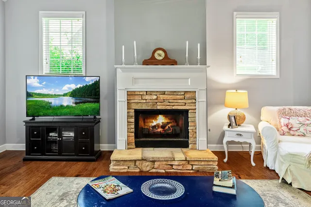 a dining room with furniture a chandelier and wooden floor