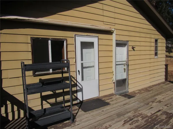 a view of a porch with wooden floor and furniture