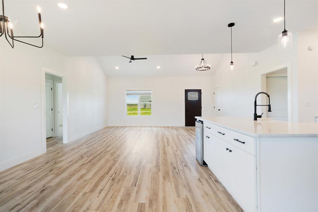 204 Private Road Sumner, TX 75486 - Photo 9 of 25 a view of a kitchen with a sink and wooden floor