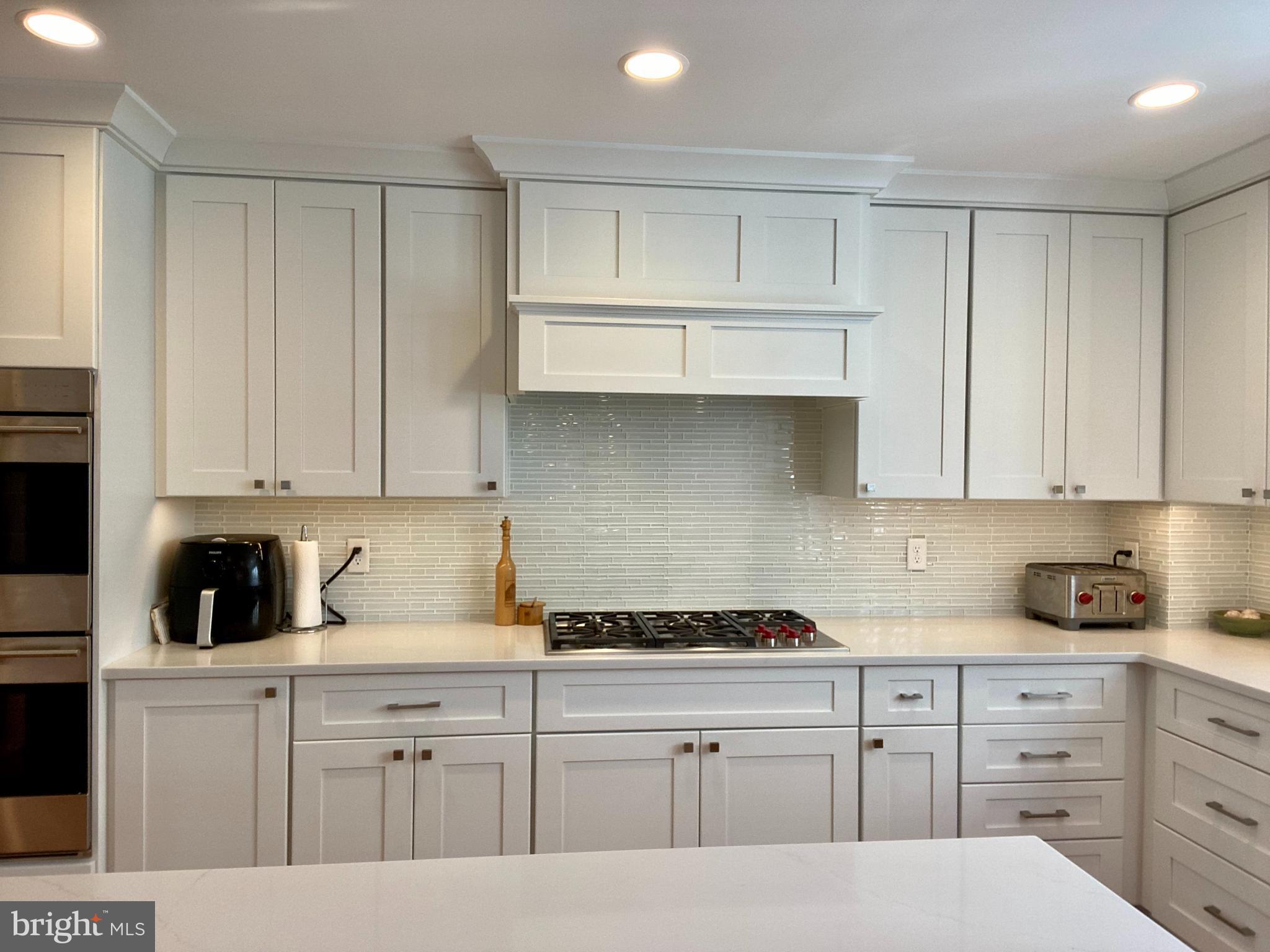 121 Upnor Road Baltimore, MD 21212 - Photo 33 of 79 a kitchen with granite countertop white cabinets and stainless steel appliances