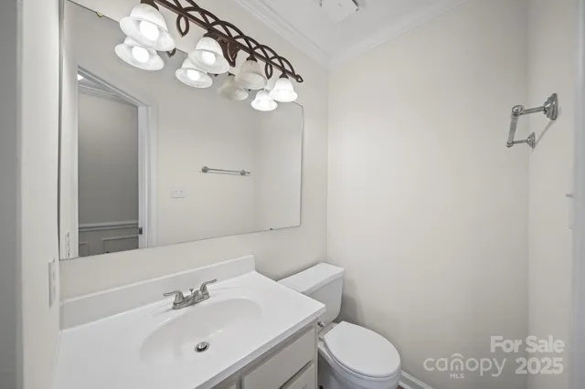 a bathroom with a sink vanity mirror and toilet
