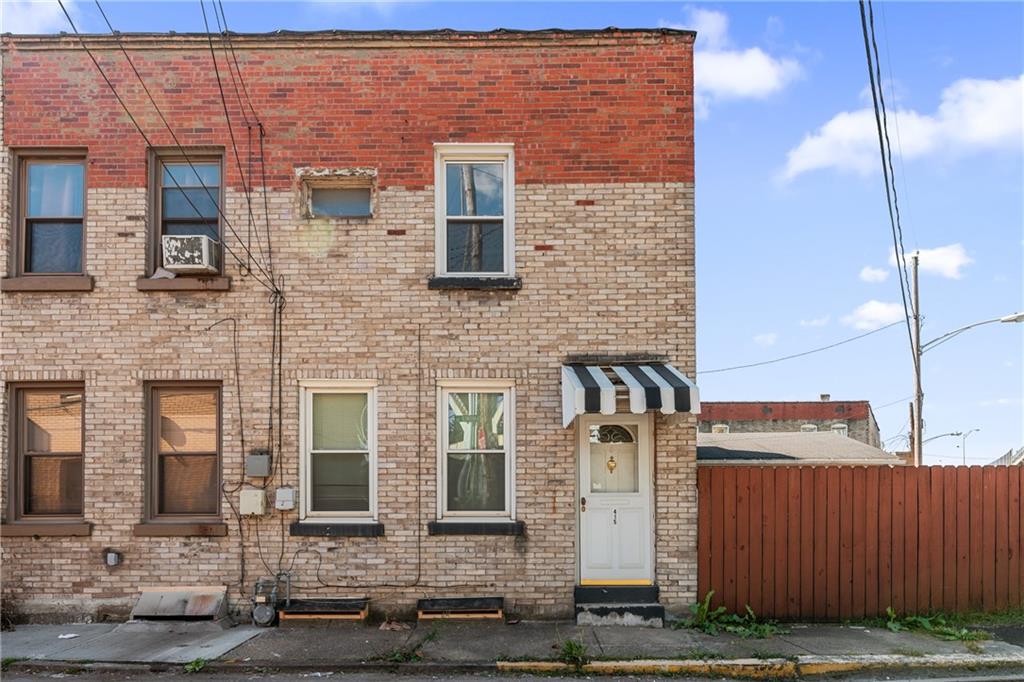 415 Gardner Street McKees Rocks, PA 15136 - Photo 1 of 22 a front view of a building with parking area