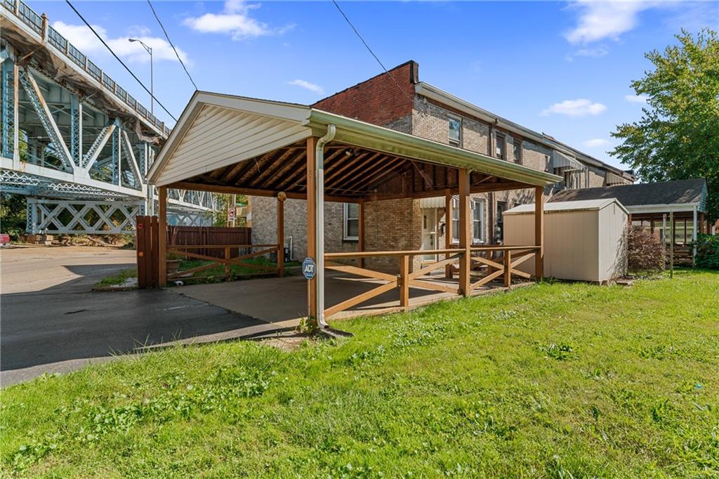 415 Gardner Street McKees Rocks, PA 15136 - Photo 4 of 22 a view of a backyard with table and chairs under an umbrella