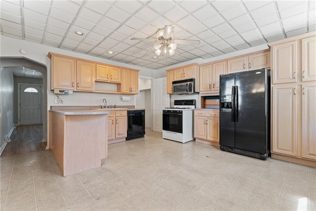 415 Gardner Street McKees Rocks, PA 15136 - Photo 8 of 22 a kitchen with a refrigerator sink and cabinets