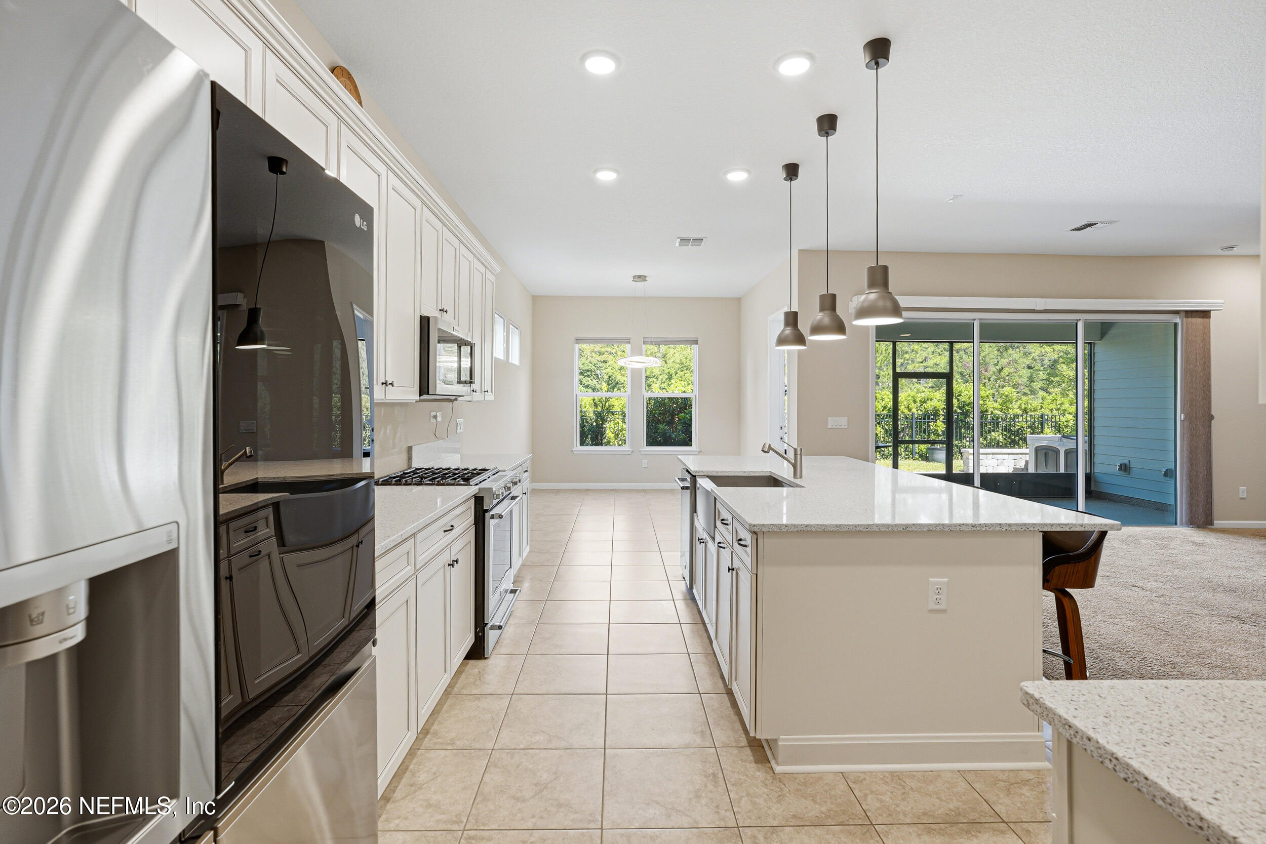 308 Rustic Mill Drive St. Augustine, FL 32092 - Photo 14 of 41 a kitchen with stainless steel appliances granite countertop a refrigerator a sink dishwasher a stove and white countertops with wooden floor