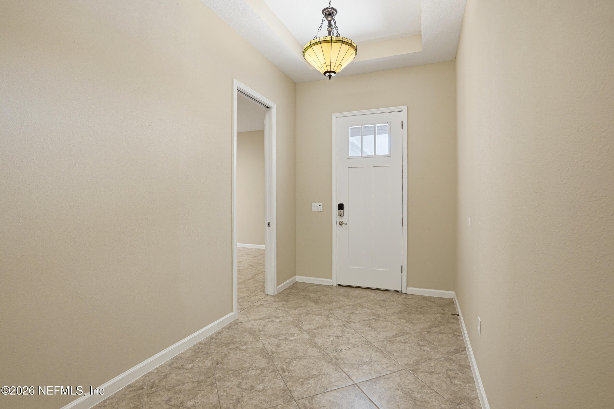 308 Rustic Mill Drive St. Augustine, FL 32092 - Photo 9 of 41 an empty room with a window and a mirror