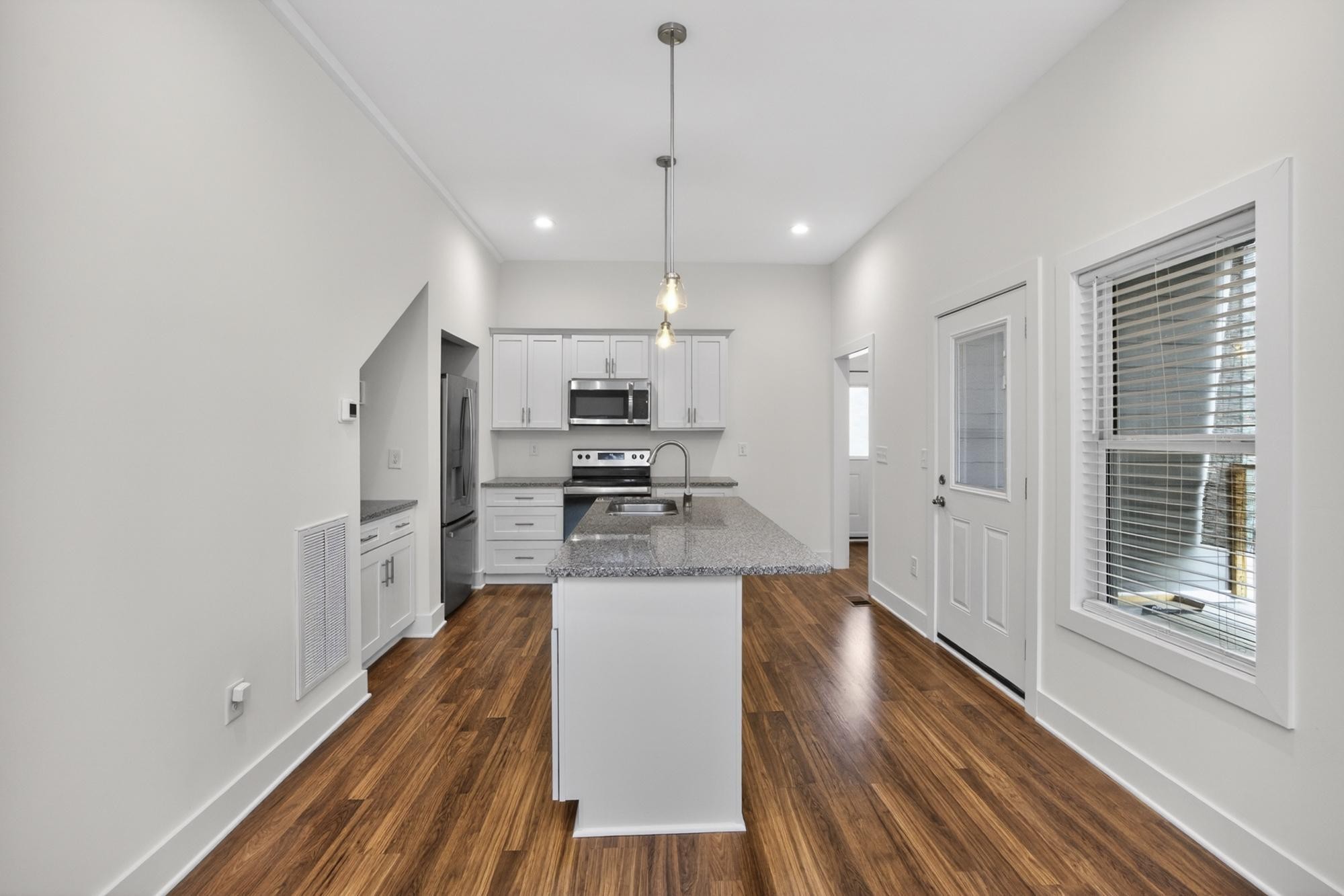 7 Decatur Street Nashville, TN 37210 - Photo 15 of 43 a kitchen with stainless steel appliances a refrigerator and a stove top oven