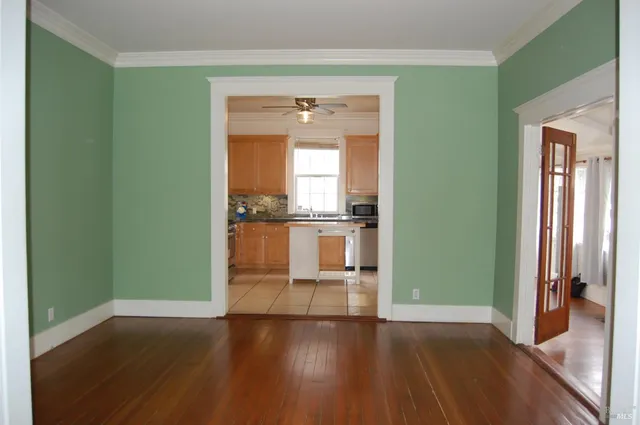 an empty room with wooden floor and a window