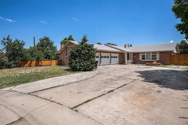 a pathway of a house with a yard