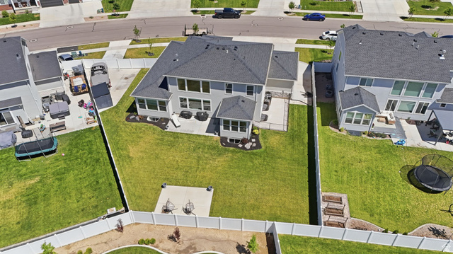 1165 West Union Bench Drive Mapleton, UT 84664 - Photo 52 of 61 Expansive rear yard featuring a large manicured lawn, multiple concrete patio areas, and perimeter fencing