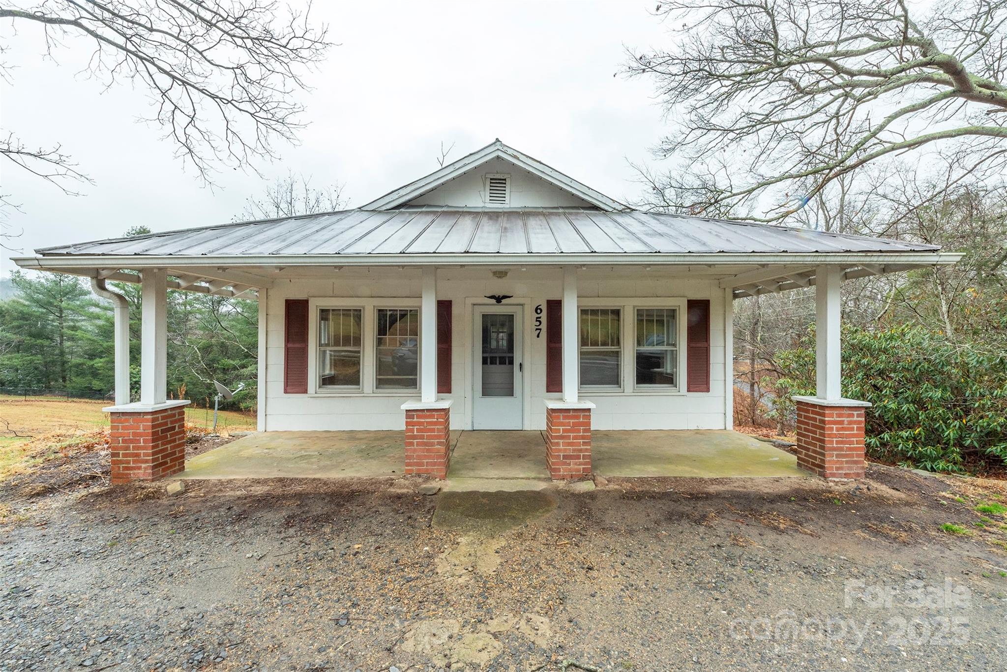 657 Old Fort Road Fairview, NC 28730 - Photo 1 of 30 a front view of a house with a yard and porch