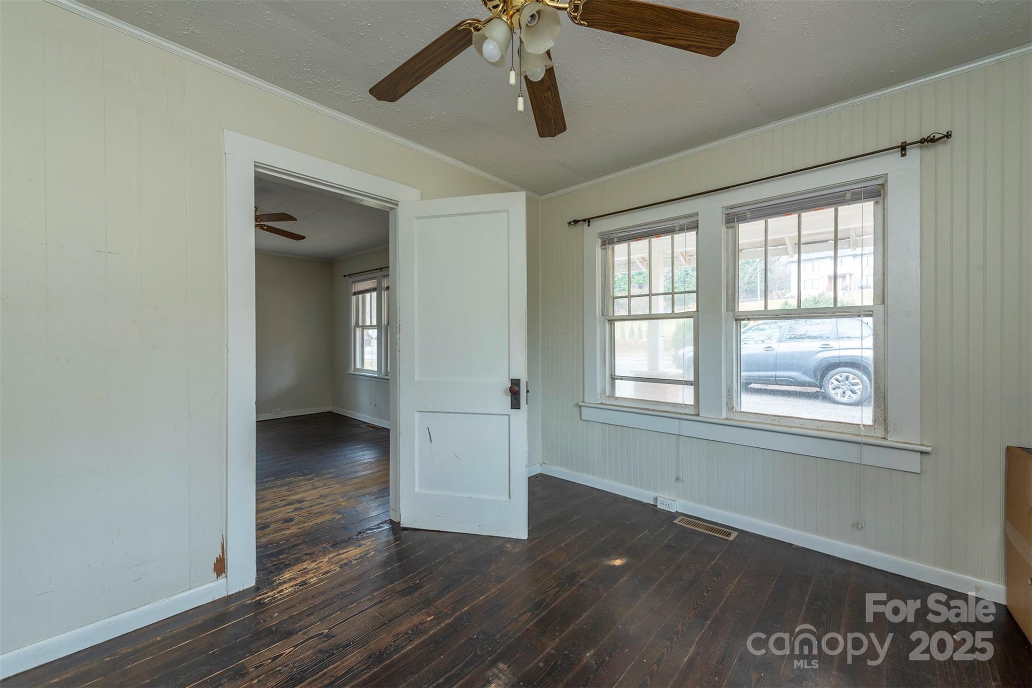 657 Old Fort Road Fairview, NC 28730 - Photo 11 of 30 an empty room with wooden floor chandelier and windows