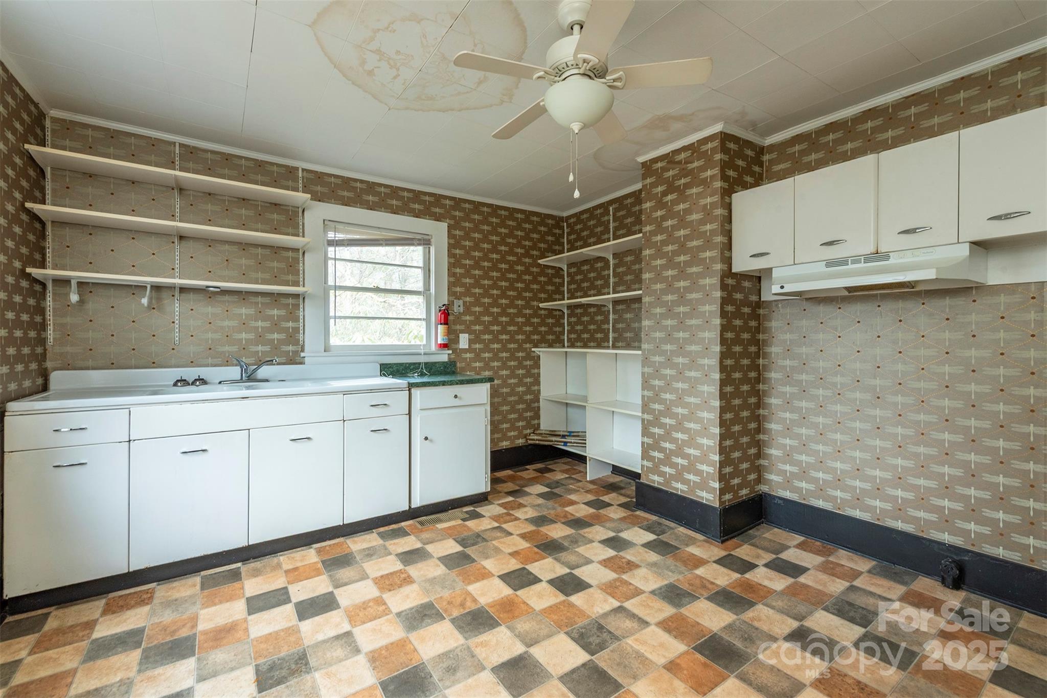 657 Old Fort Road Fairview, NC 28730 - Photo 17 of 30 a room with a granite countertop cabinets sink and a window