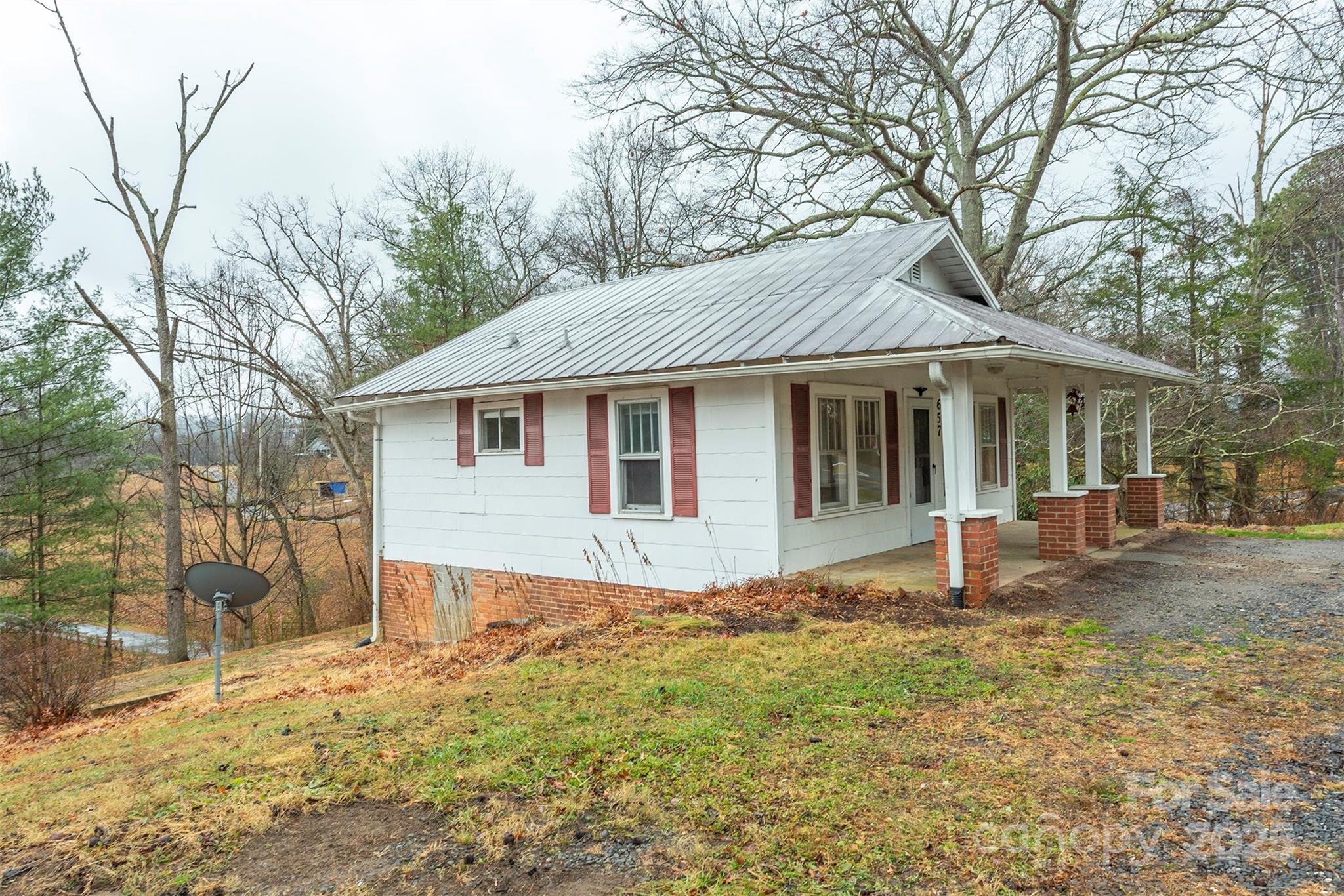 657 Old Fort Road Fairview, NC 28730 - Photo 3 of 30 a front view of a house with a yard and porch