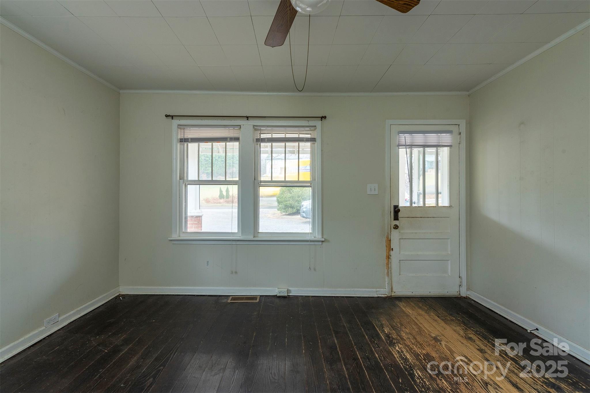 657 Old Fort Road Fairview, NC 28730 - Photo 6 of 30 an empty room with wooden floor cabinet and windows