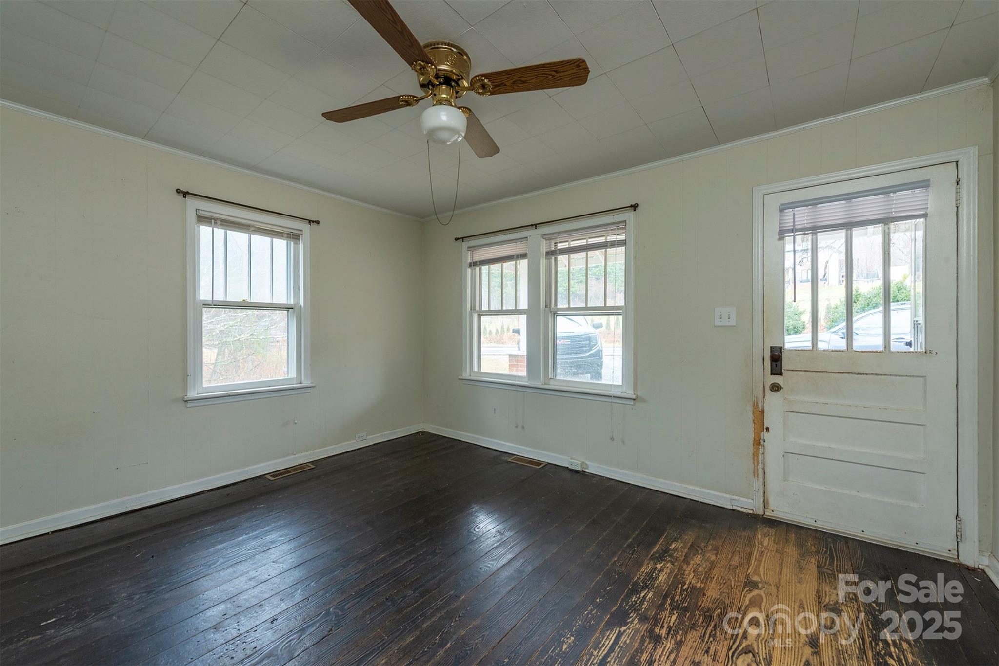 657 Old Fort Road Fairview, NC 28730 - Photo 7 of 30 a view of an empty room with a window and wooden floor