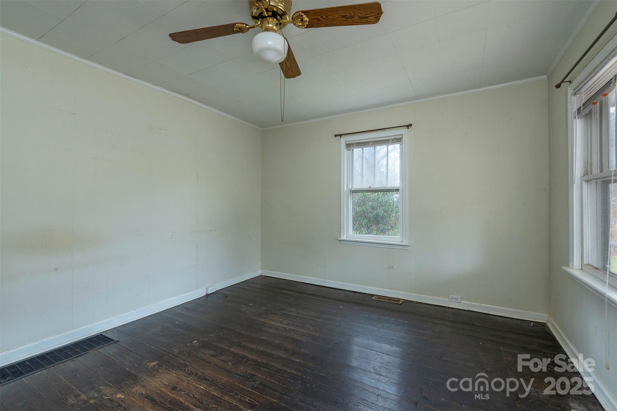 657 Old Fort Road Fairview, NC 28730 - Photo 9 of 30 an empty room with wooden floor fan and windows