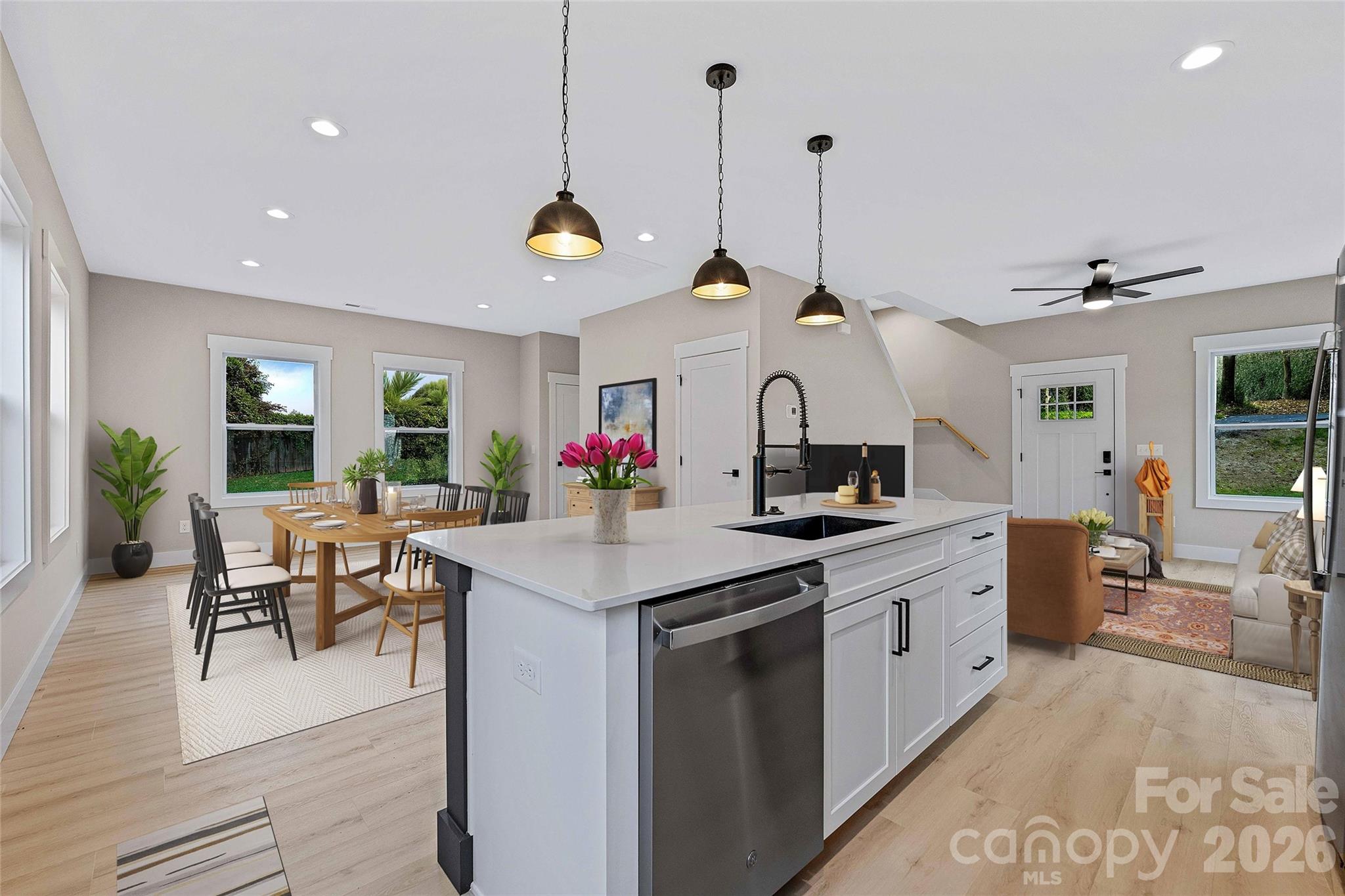 428 Hazel Mill Road Asheville, NC 28806 - Photo 15 of 46 a kitchen with kitchen island stainless steel appliances a dining table and chairs