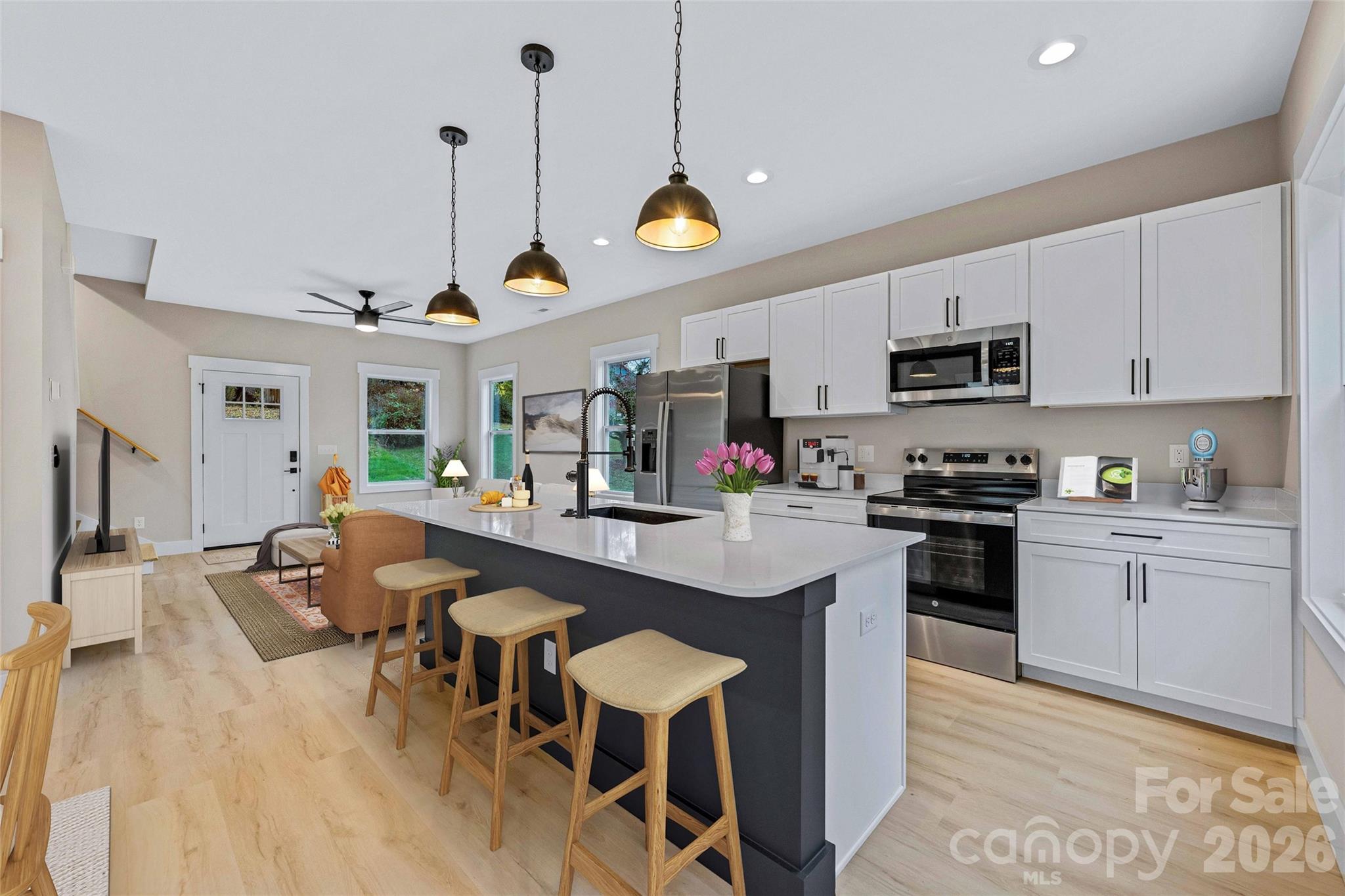 428 Hazel Mill Road Asheville, NC 28806 - Photo 20 of 46 a kitchen with kitchen island granite countertop a sink a counter space appliances and cabinets