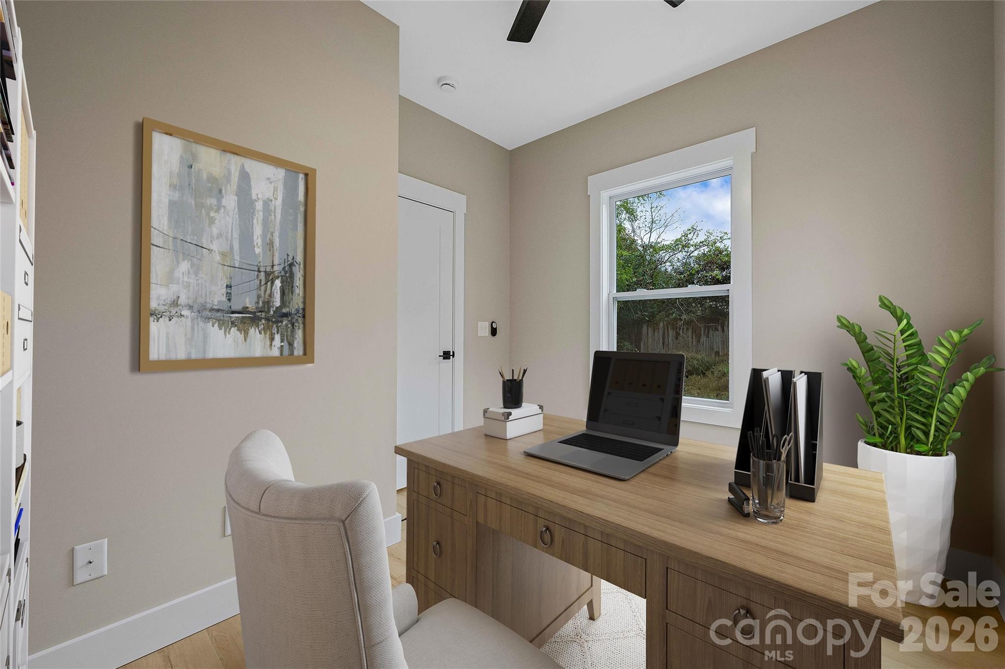 428 Hazel Mill Road Asheville, NC 28806 - Photo 26 of 46 a view of a workspace with furniture and a potted plant