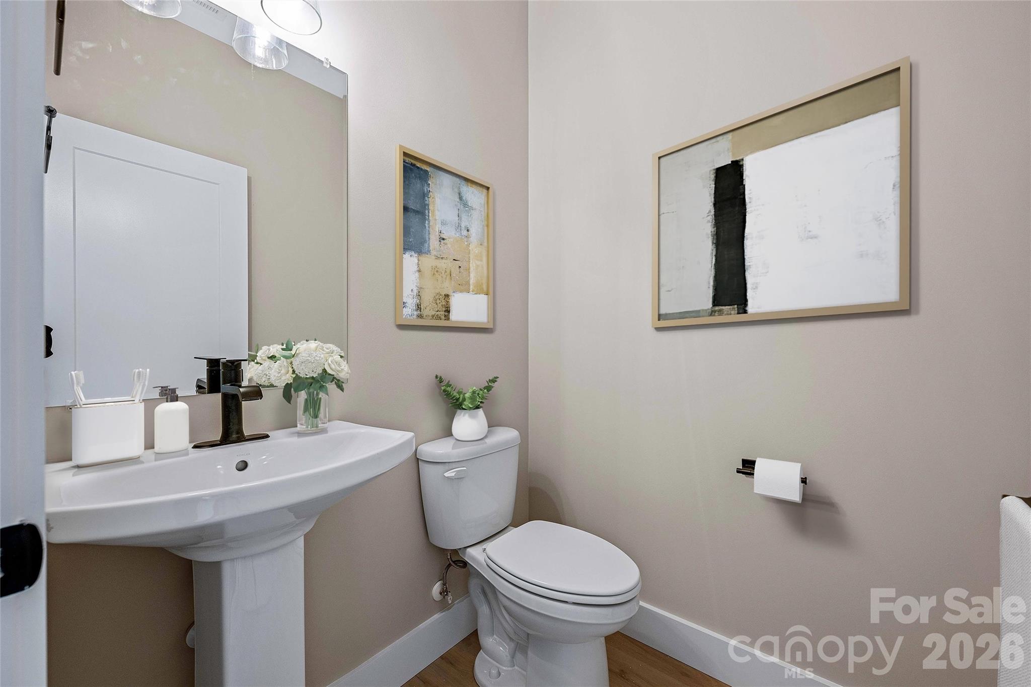 428 Hazel Mill Road Asheville, NC 28806 - Photo 27 of 46 a bathroom with a toilet sink and mirror