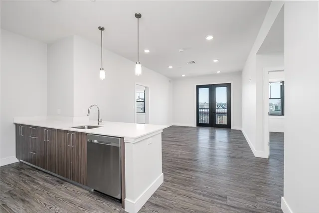 a view of a kitchen center island with wooden floor